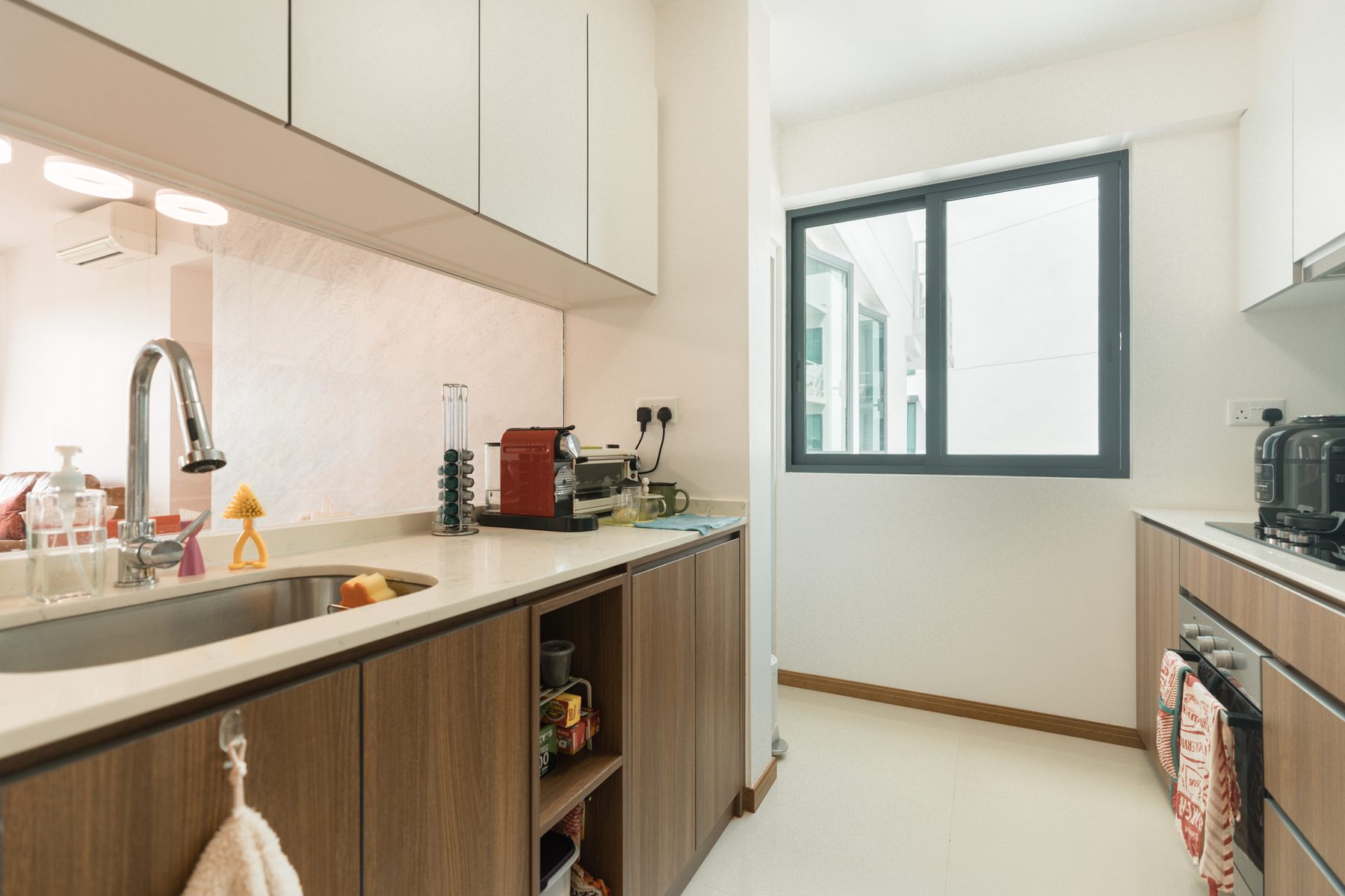 Kitchen prep area with sink, white quartz counter, and window for natural ventilation